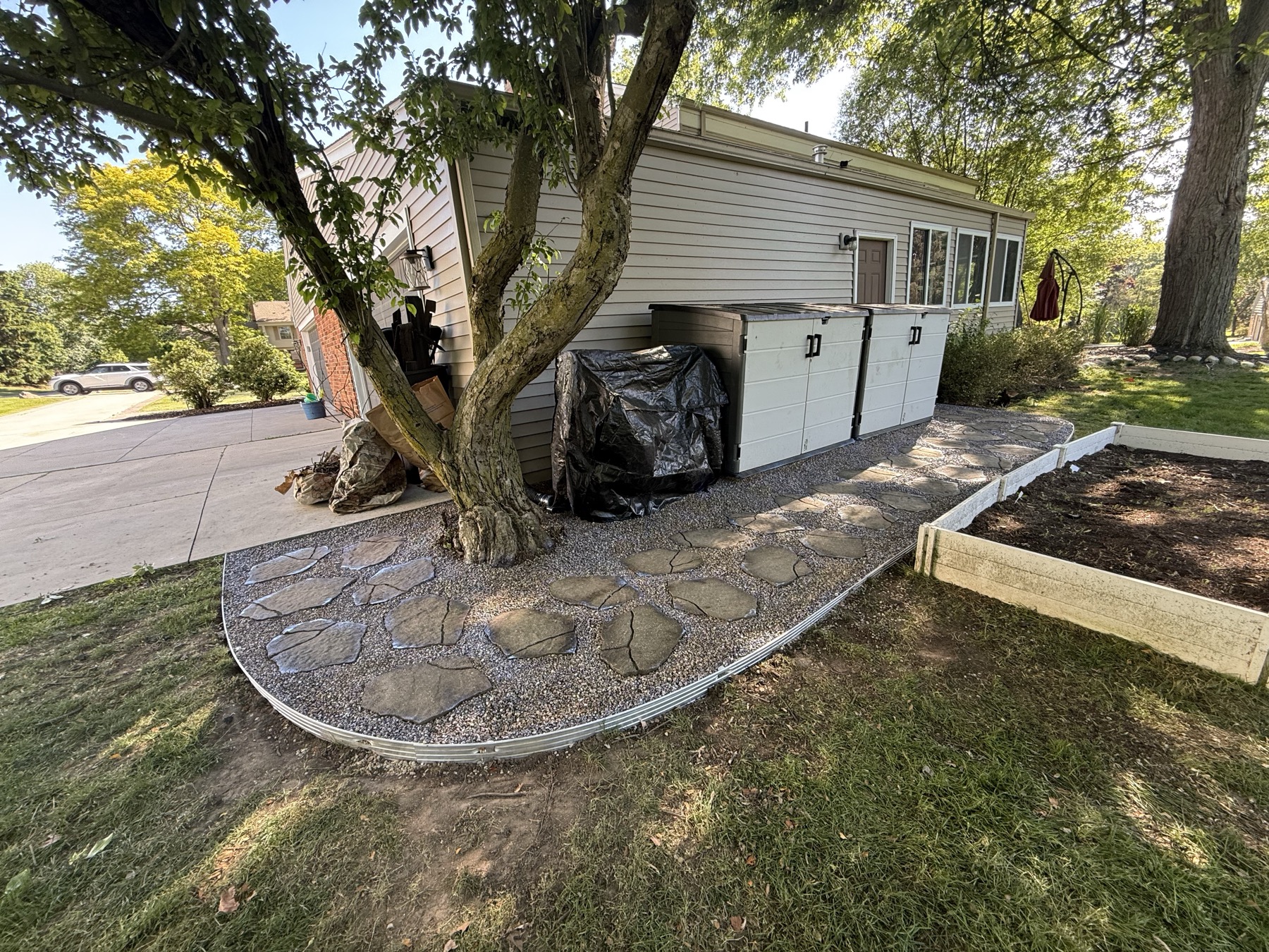 New flagstone walkway with clean gravel joints along the same side yard